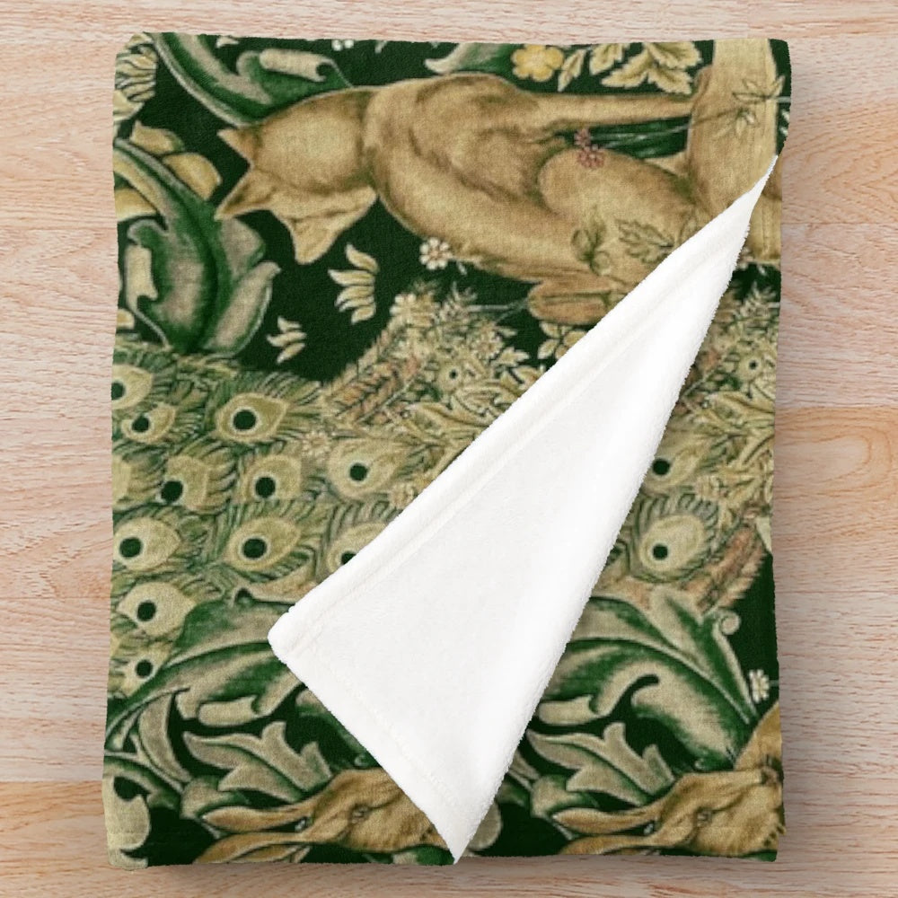 Plush blanket featuring green forest animals, peacocks, and a floral pattern