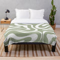 Plush blanket with abstract sage green and white minimalist pattern