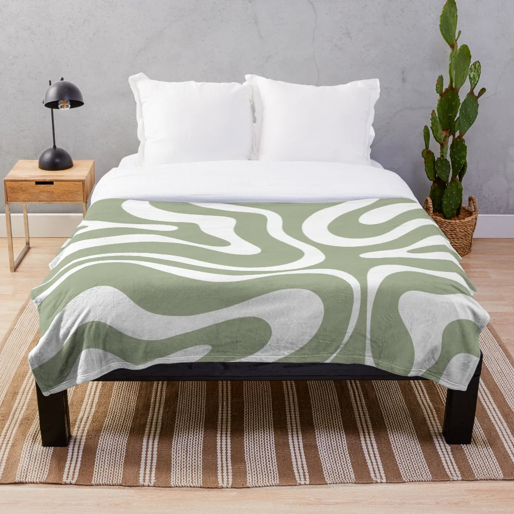 Plush blanket with abstract sage green and white minimalist pattern