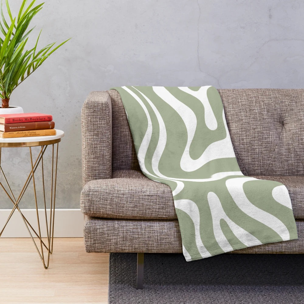 Plush blanket with abstract sage green and white minimalist pattern