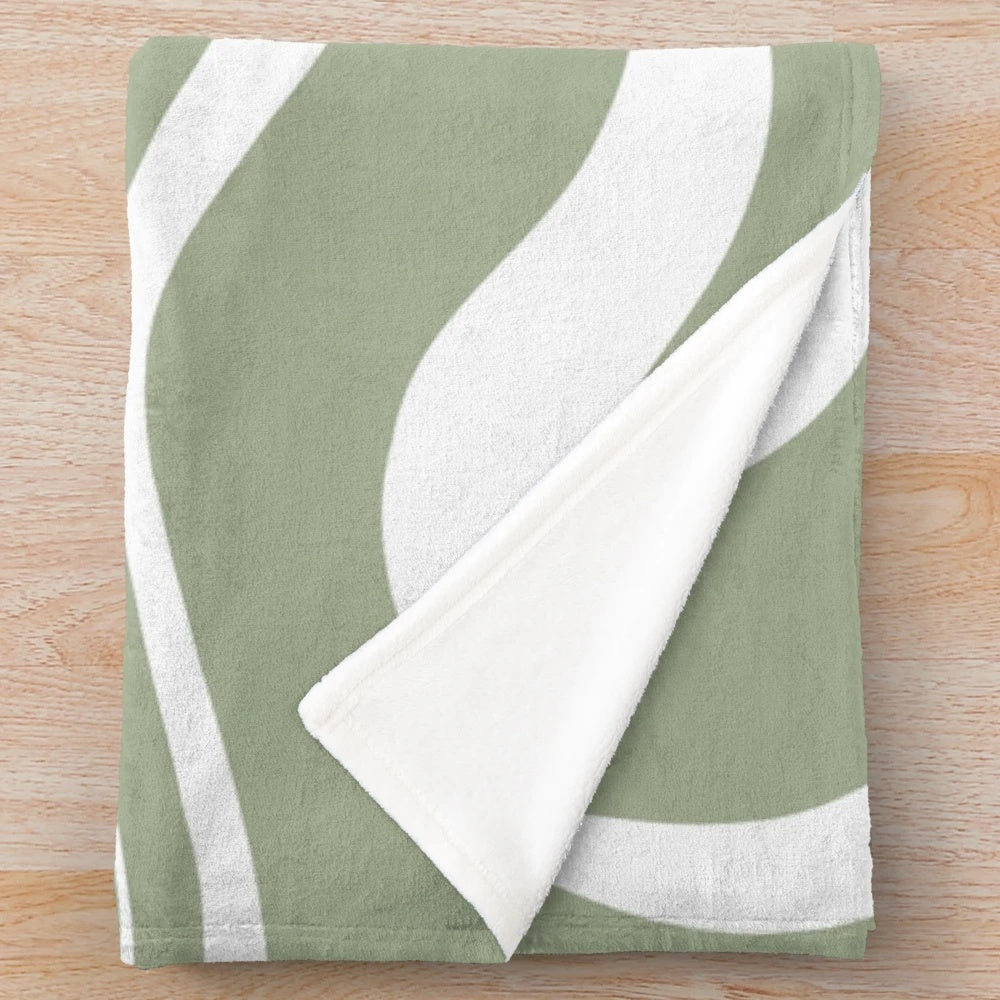 Plush blanket with abstract sage green and white minimalist pattern