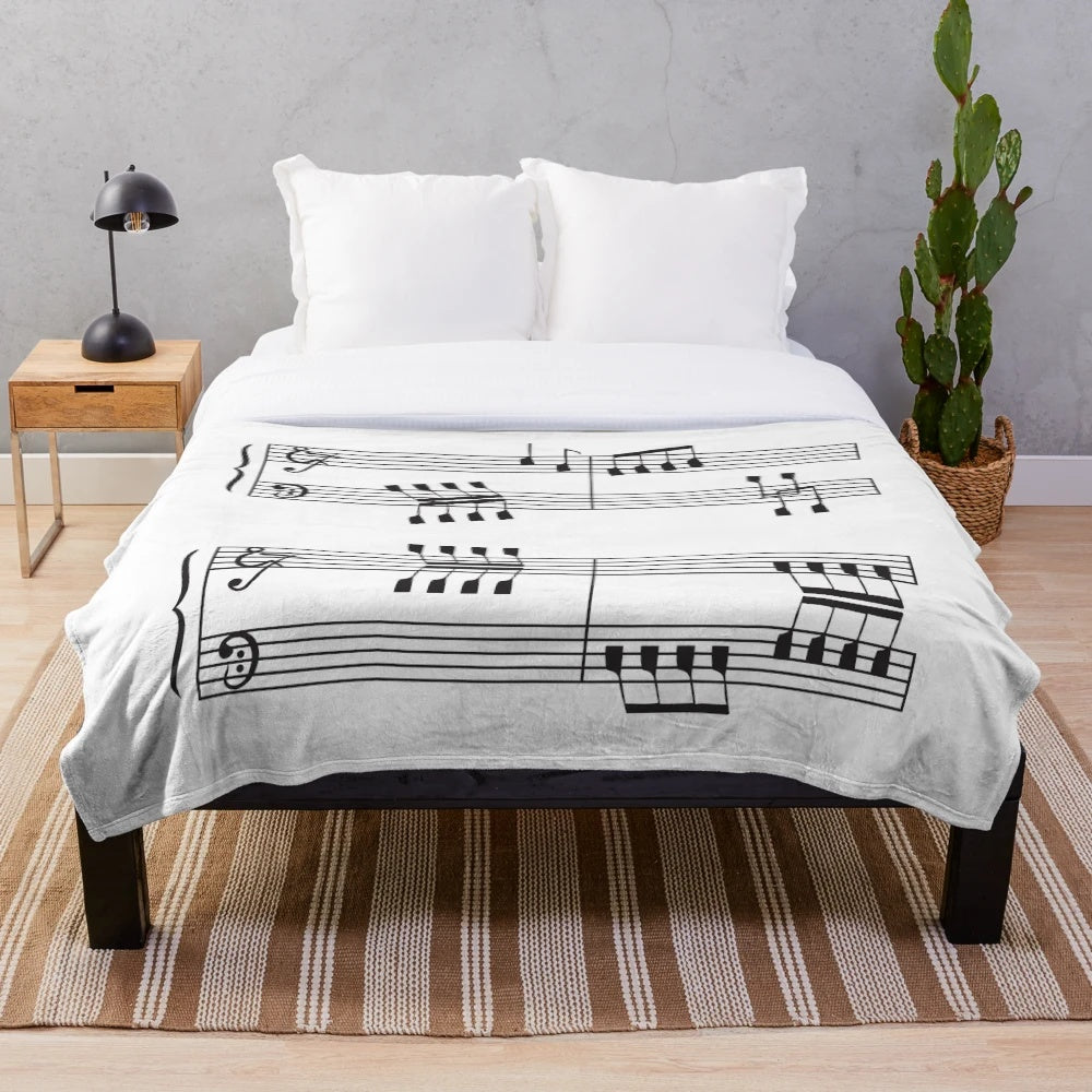 Plush blanket featuring musical notes design for rowing enthusiasts