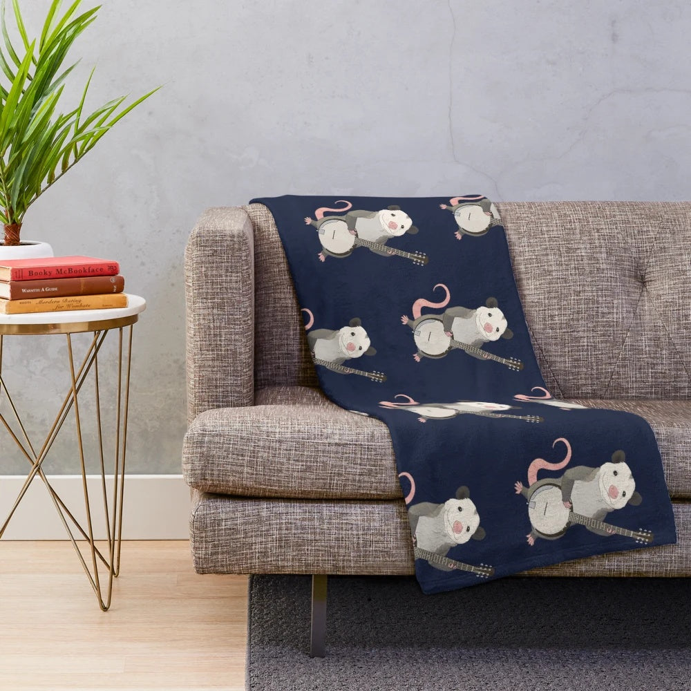 Plush blanket featuring a possum playing the banjo instrument