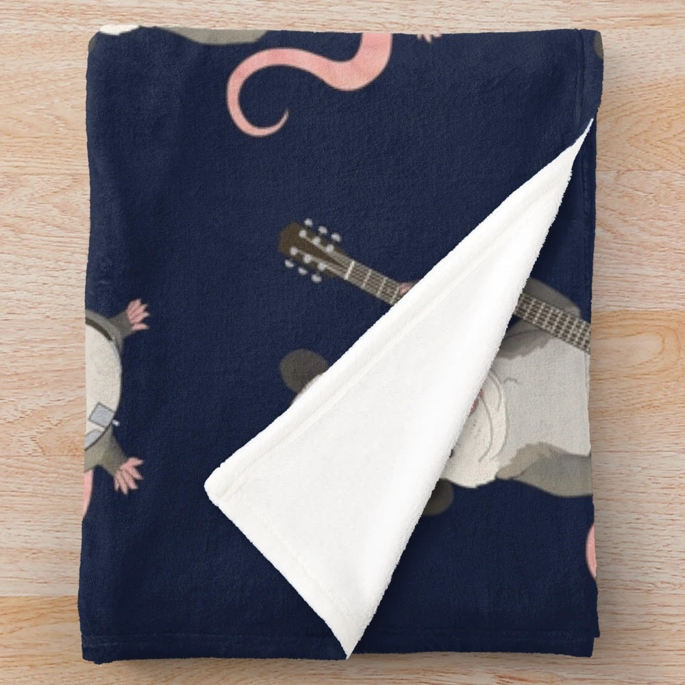 Plush blanket featuring a possum playing the banjo instrument