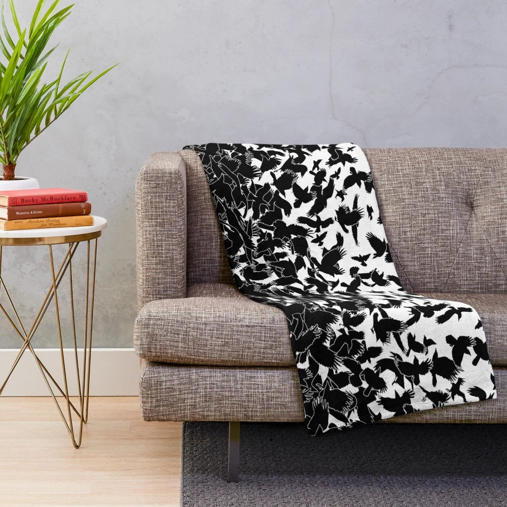Plush blanket with abstract raven, crow, and flying birds pattern