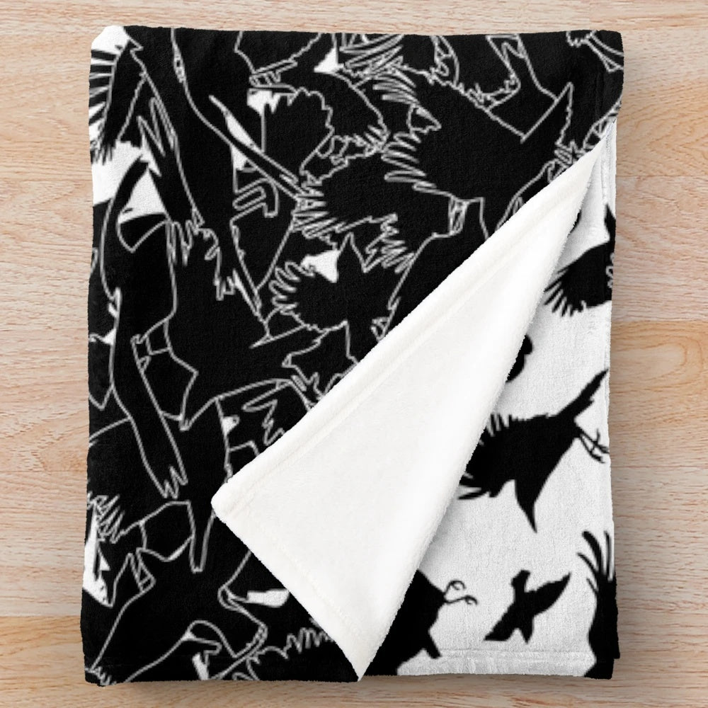 Plush blanket with abstract raven, crow, and flying birds pattern