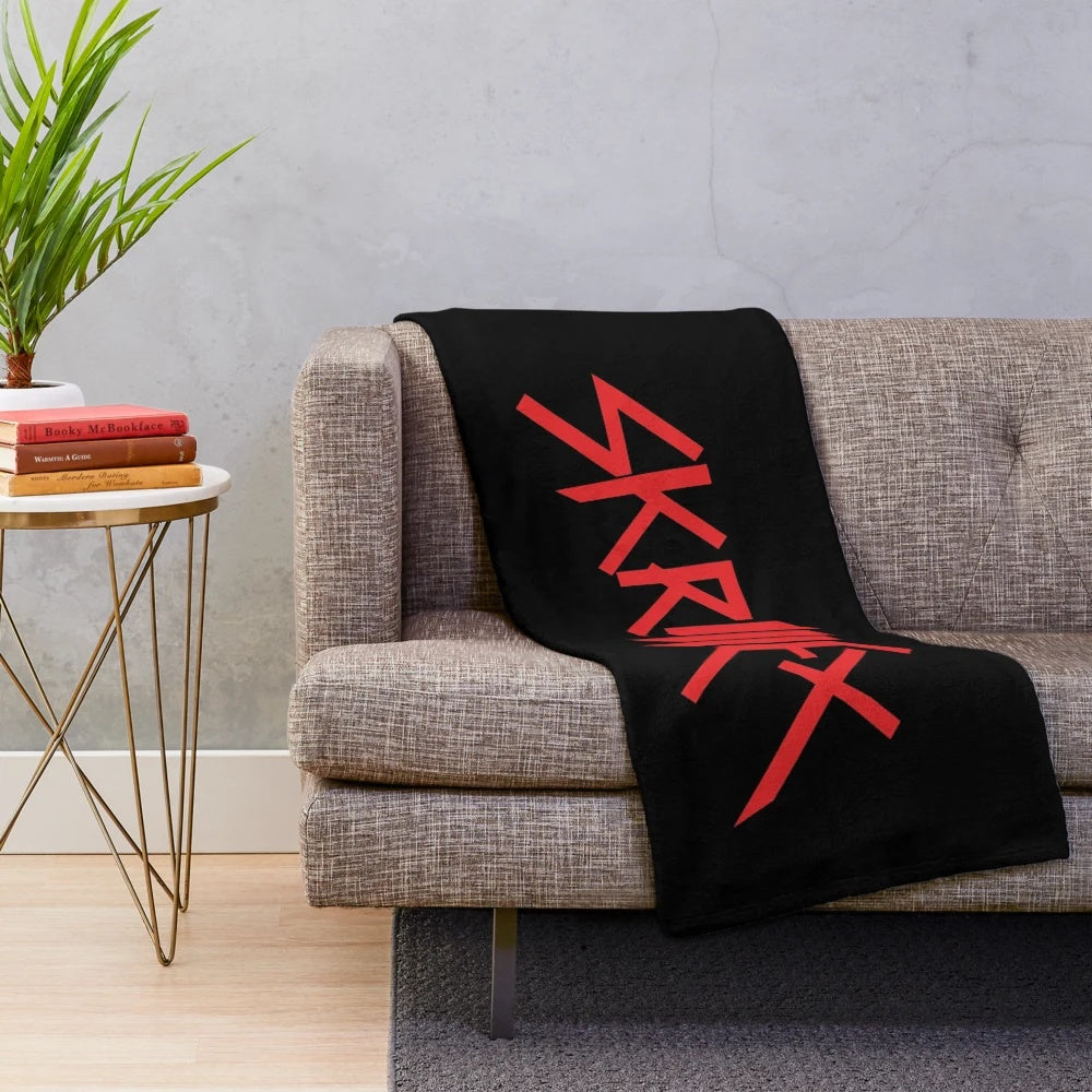 Plush blanket with Skrillex inspired logo design
