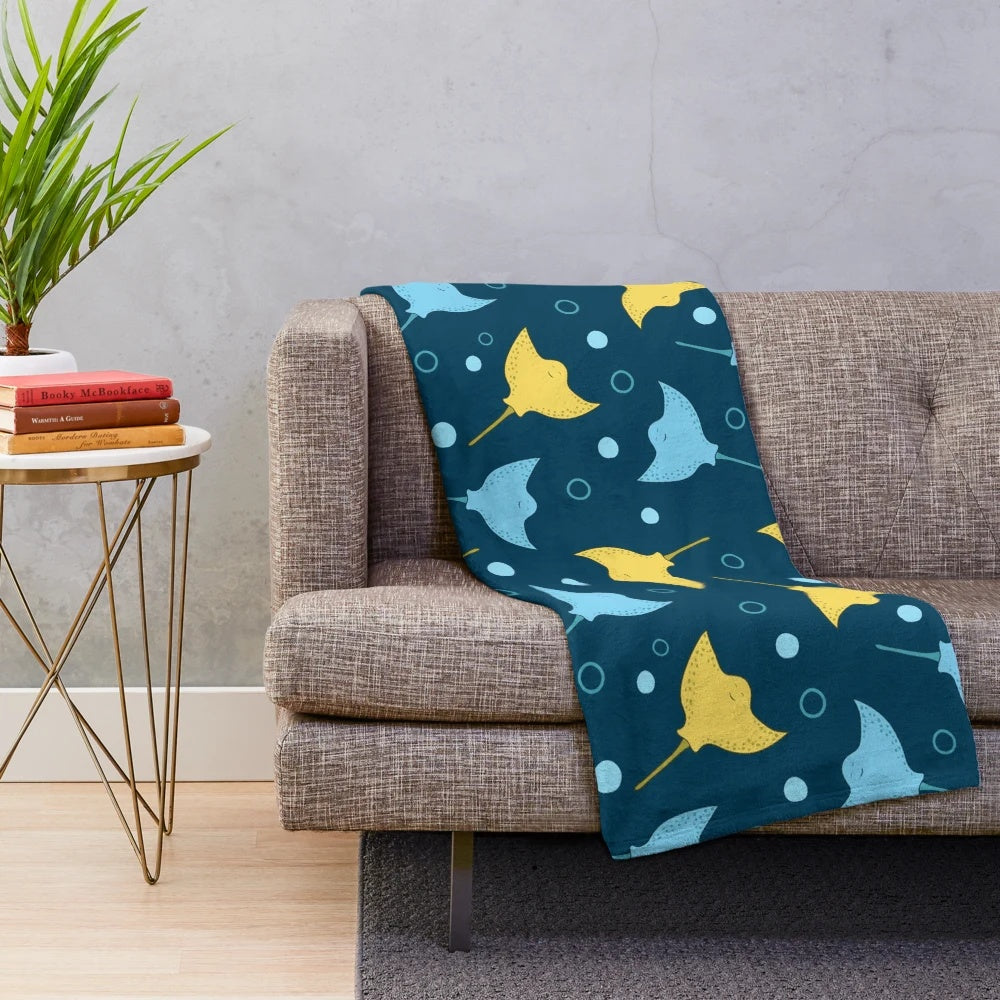 Plush blanket with a detailed stingray pattern on a dark blue background