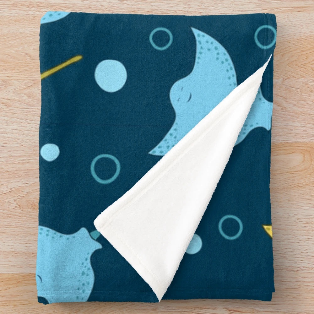 Plush blanket with a detailed stingray pattern on a dark blue background