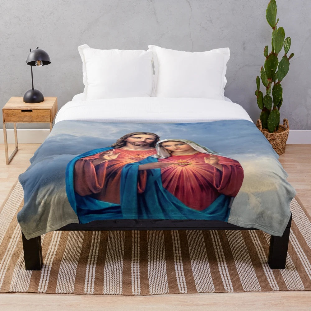 Plush blanket featuring detailed artwork of the twin hearts of Jesus and Mary against a sky background