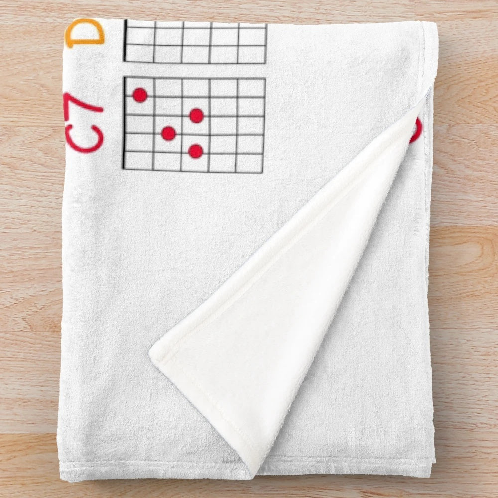 Plush blanket with visual guide for learning guitar chords