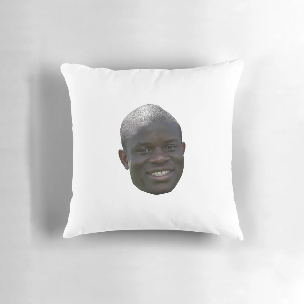 Realistic looking plush football pillow featuring the head of N'Golo Kante, the renowned French footballer.