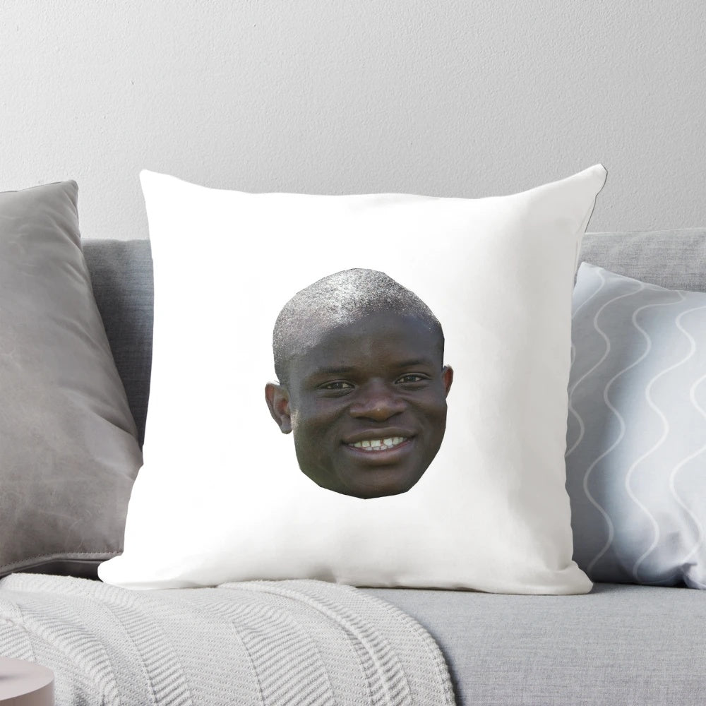 Realistic looking plush football pillow featuring the head of N'Golo Kante, the renowned French footballer.