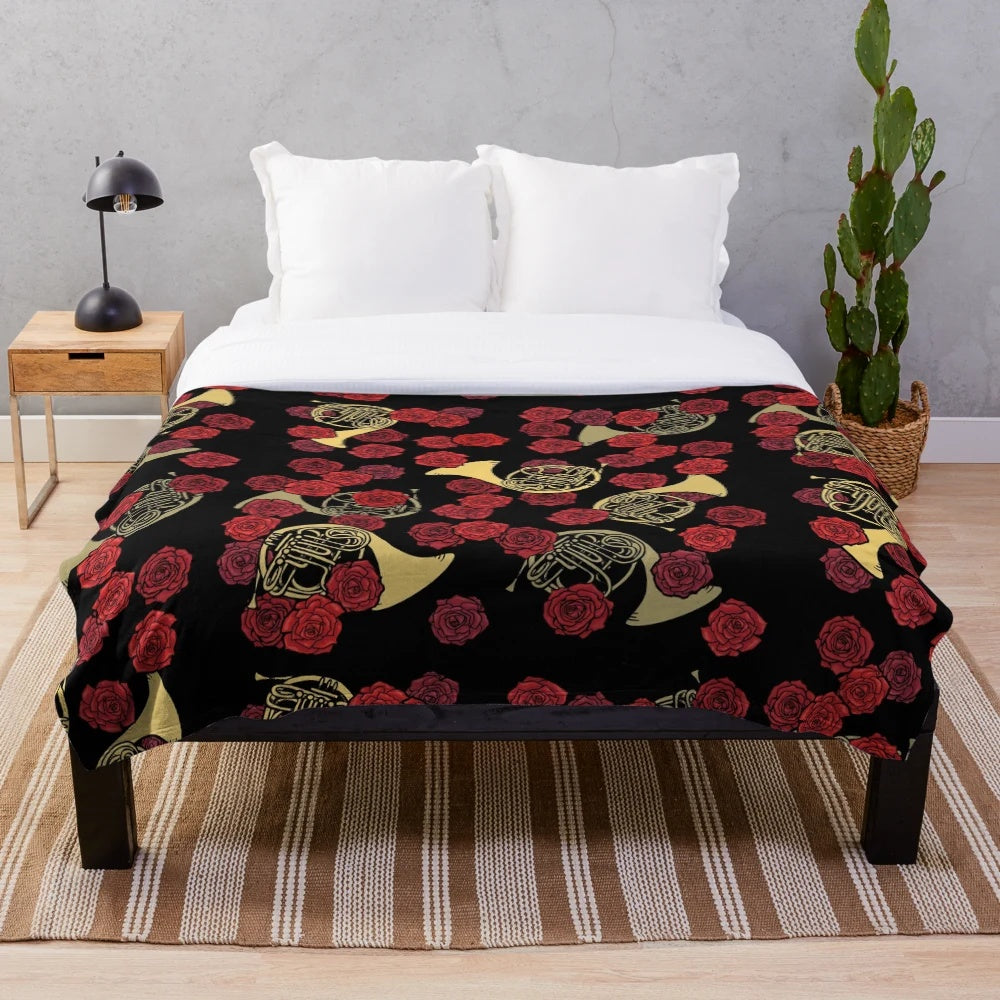 Soft and cozy plush blanket featuring a beautiful design of French horns and roses