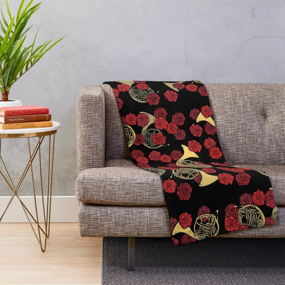 Soft and cozy plush blanket featuring a beautiful design of French horns and roses
