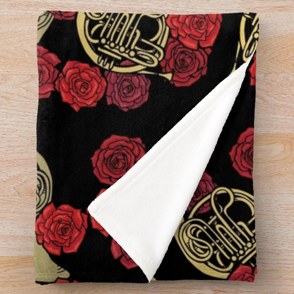 Soft and cozy plush blanket featuring a beautiful design of French horns and roses