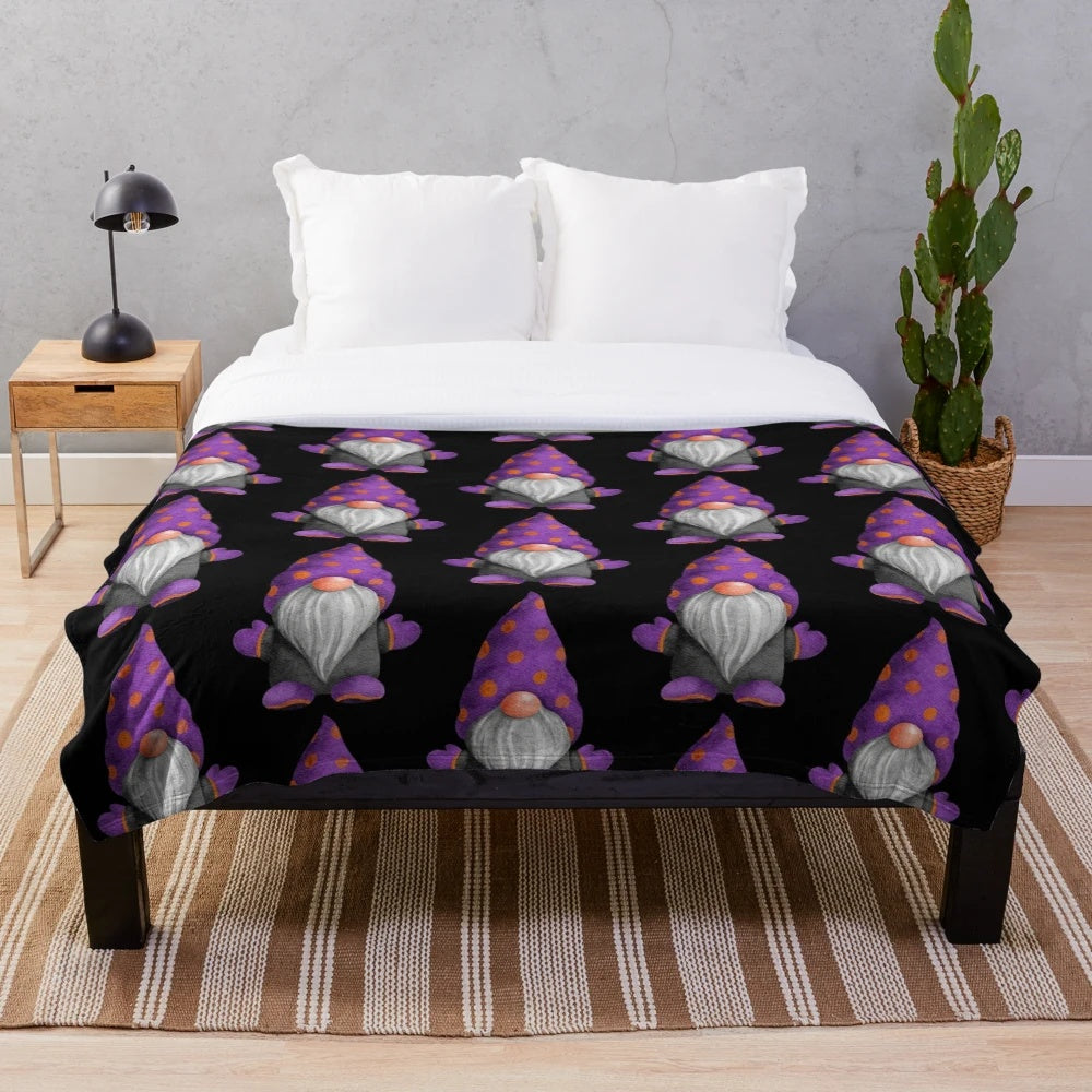 A cozy plush blanket featuring a cute gnome design with orange and purple polka dots, perfect for autumn and Halloween decor.