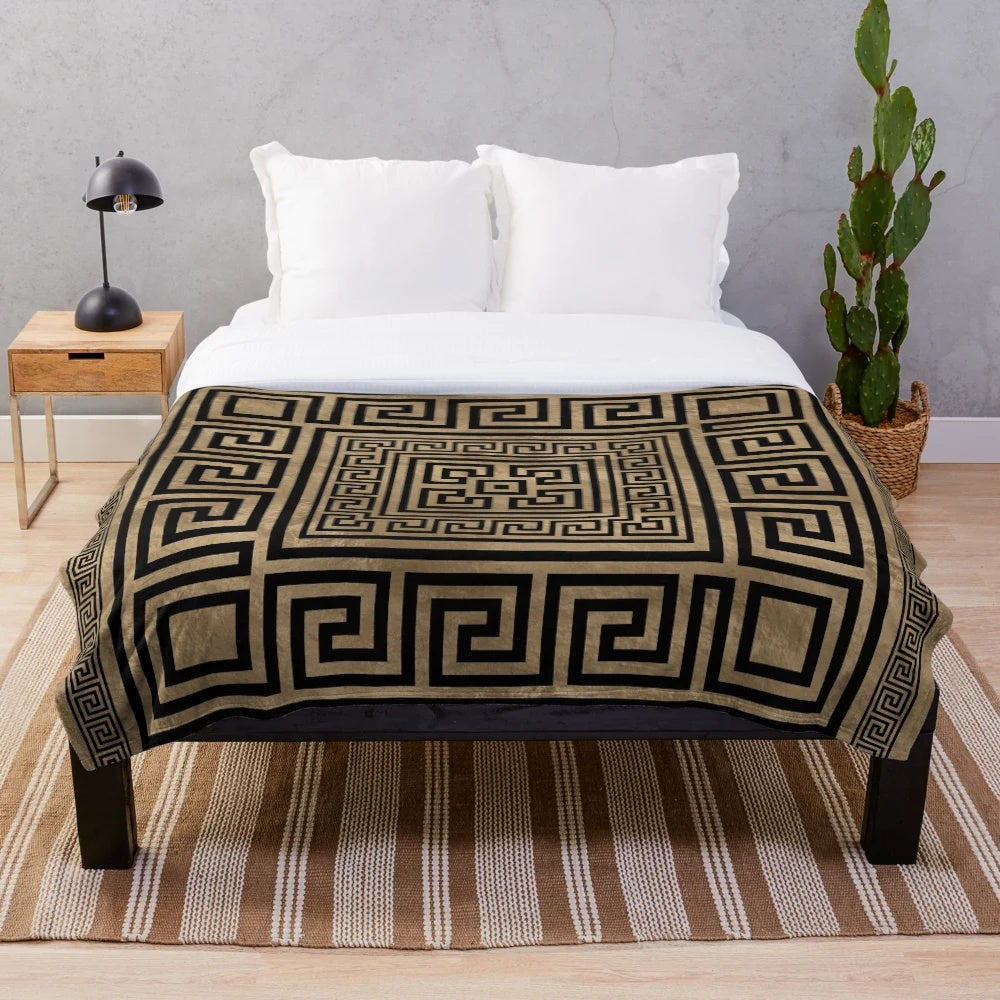 Plush blanket with black and gold Greek key pattern design