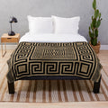 Plush blanket with black and gold Greek key pattern design