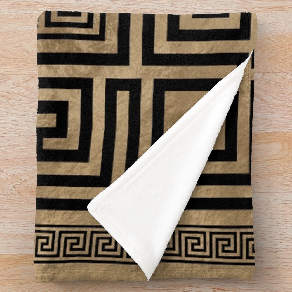 Plush blanket with black and gold Greek key pattern design