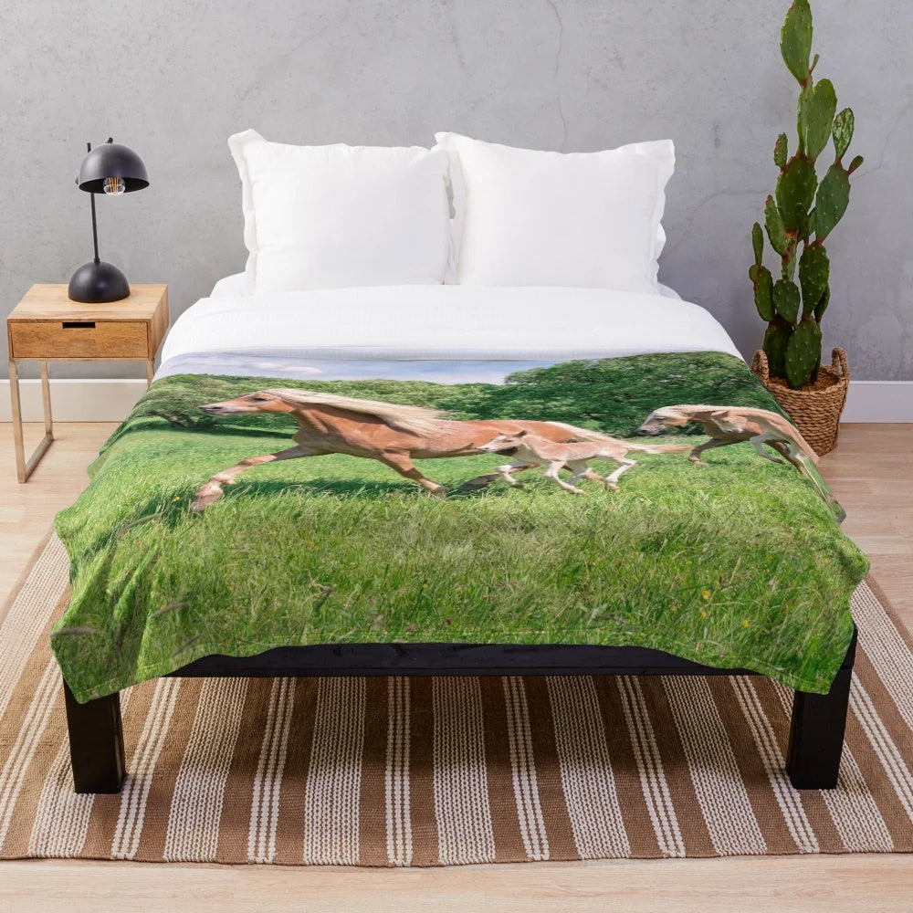 Haflinger horses running together in a natural meadow scene on a plush blanket