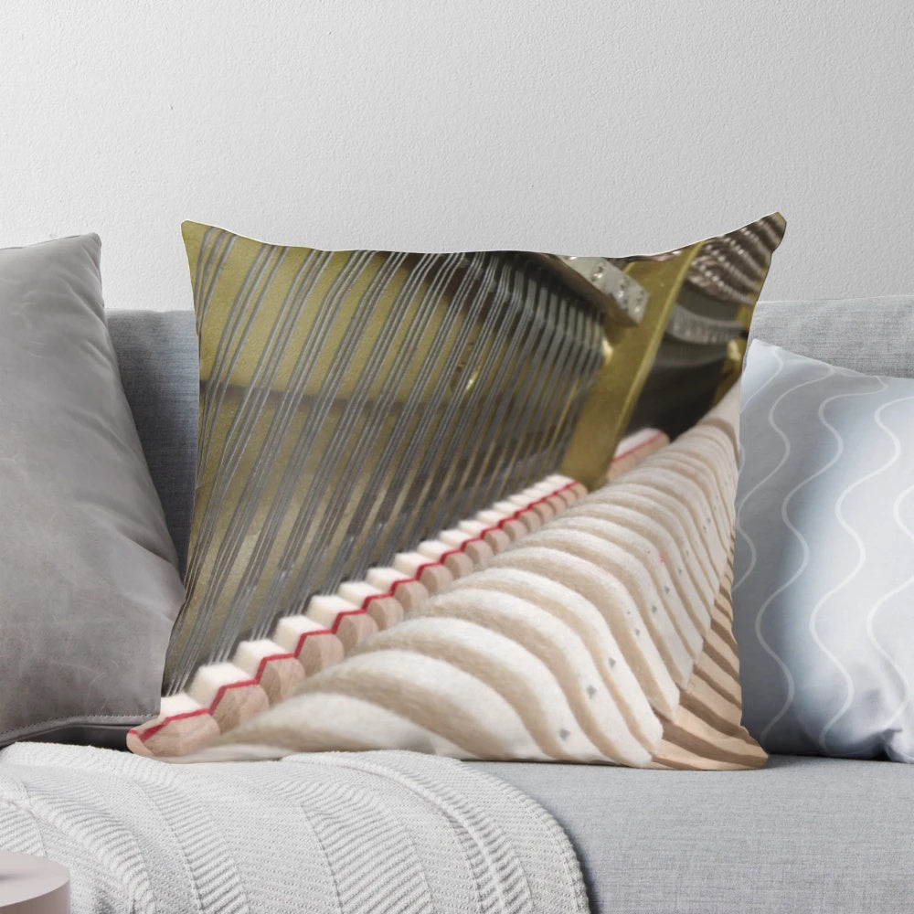 Closeup of a plush "Inside the Piano" pillow, showcasing the intricate details of piano strings and mechanics.