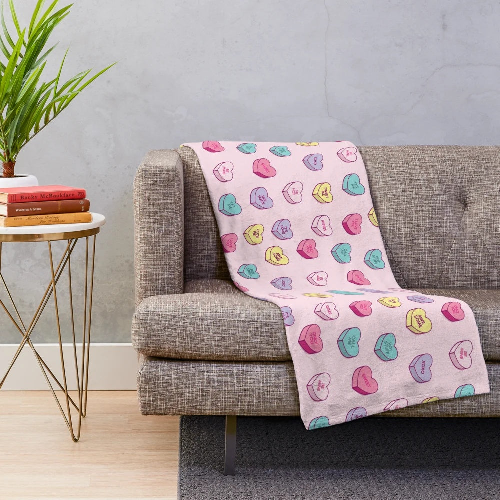 Soft and cozy plush blanket with a pastel conversation hearts pattern