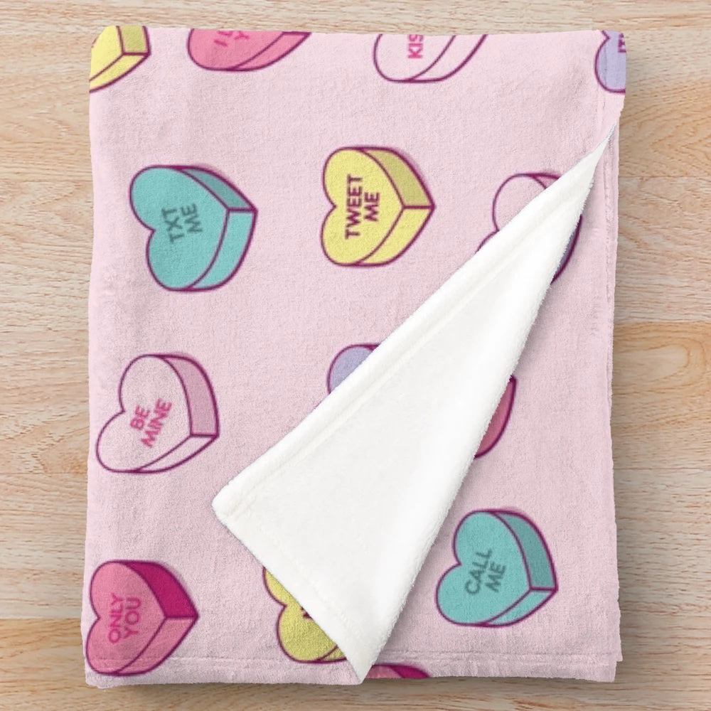 Soft and cozy plush blanket with a pastel conversation hearts pattern