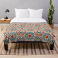 Plush patchwork blanket with a geometric terracotta and teal design