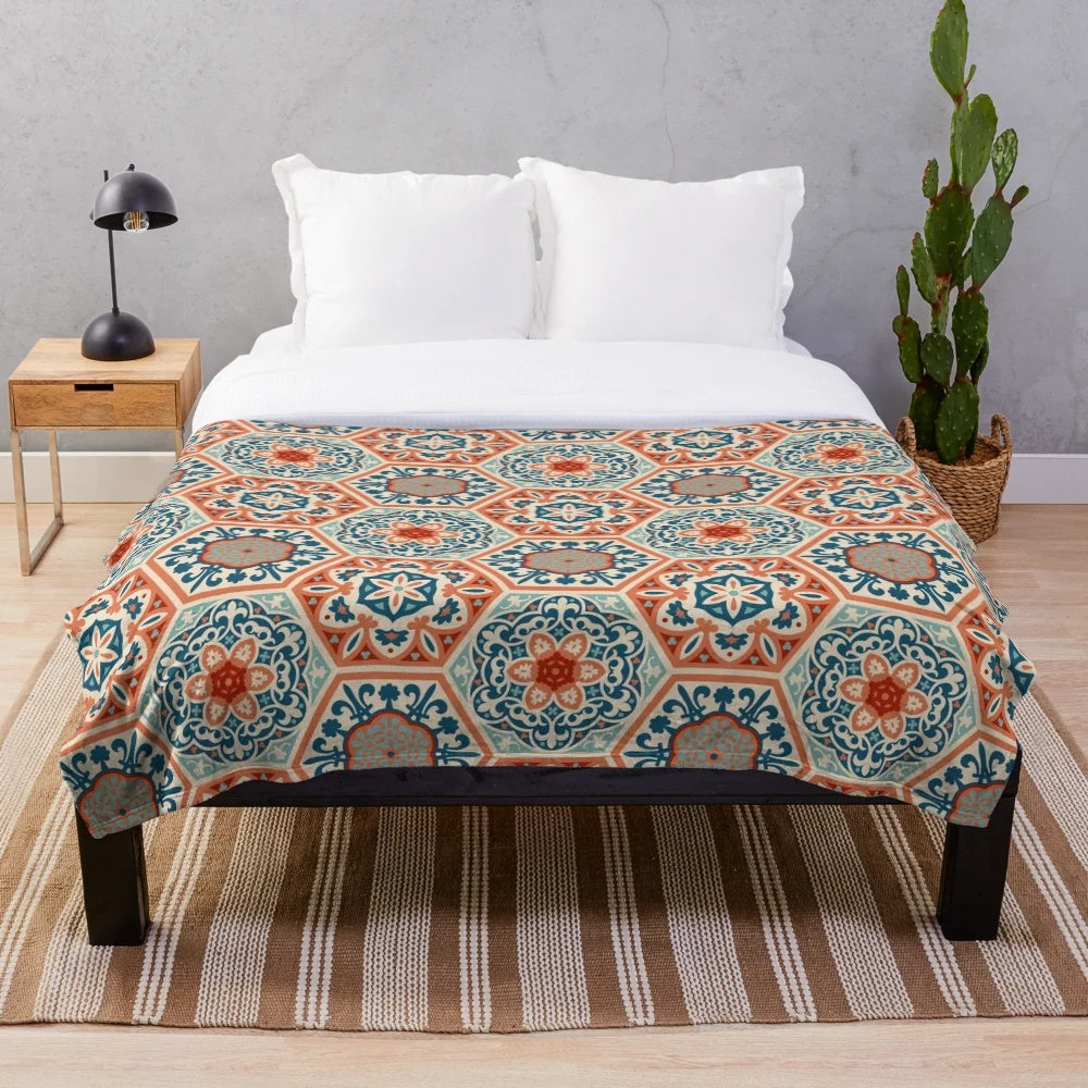 Plush patchwork blanket with a geometric terracotta and teal design