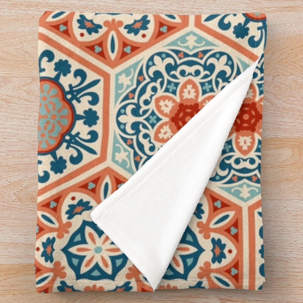 Plush patchwork blanket with a geometric terracotta and teal design