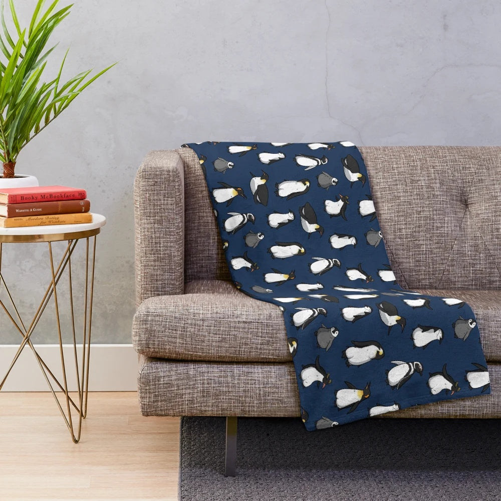 A cozy and cute plush blanket with a penguin pattern in dark blue