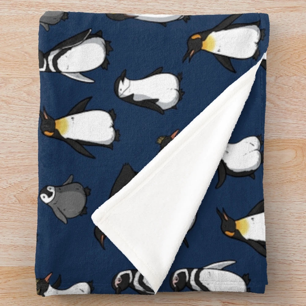A cozy and cute plush blanket with a penguin pattern in dark blue