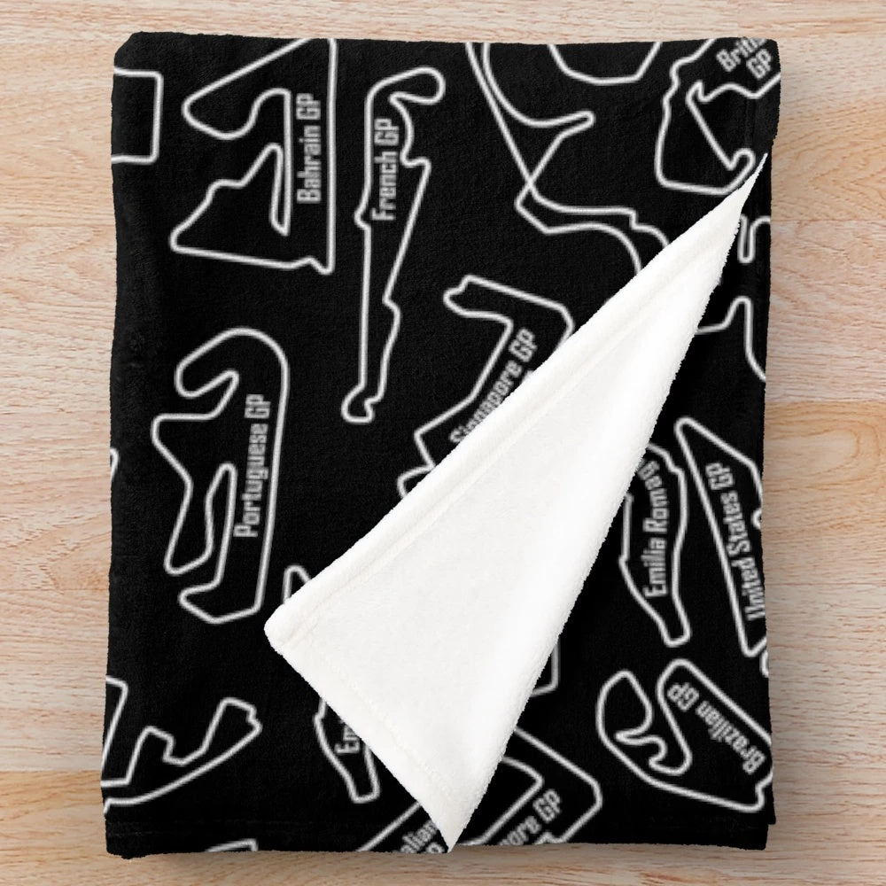 Plush blanket with racing circuit and sports car patterns