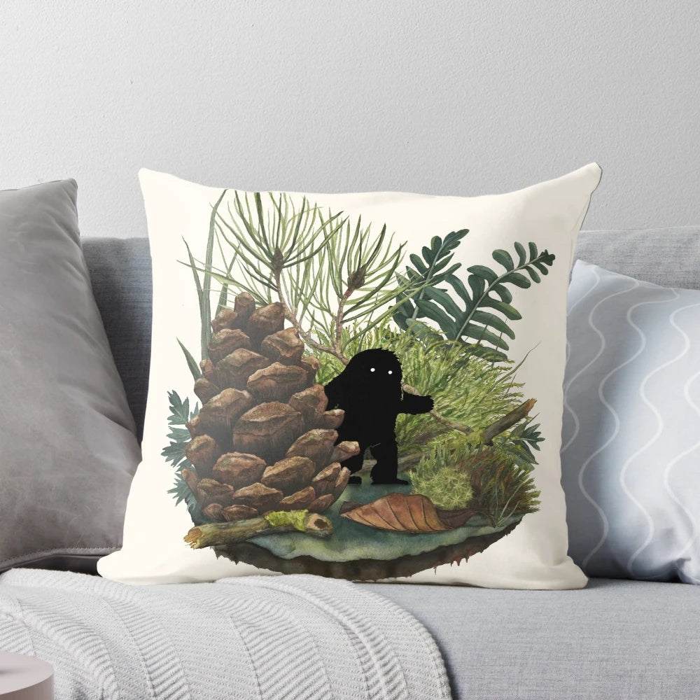 A soft, plush pillow featuring a whimsical watercolor illustration of a tiny sasquatch or woodland creature.