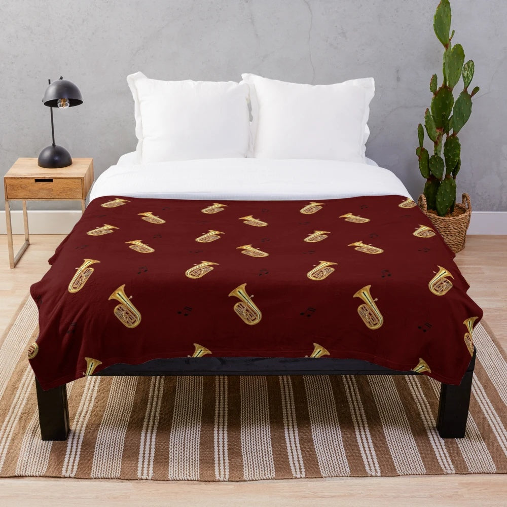 Cozy plush blanket with a tuba pattern design, perfect for music lovers