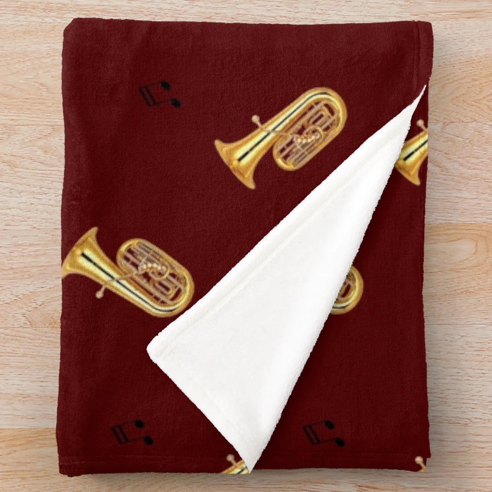 Cozy plush blanket with a tuba pattern design, perfect for music lovers