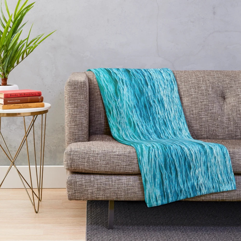 Turquoise plush blanket with ocean waves and water ripples design