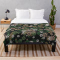 Camo plush blanket with woodland pattern and paw prints