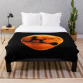 Poodle dog silhouette against the moon on a cozy plush blanket for Halloween