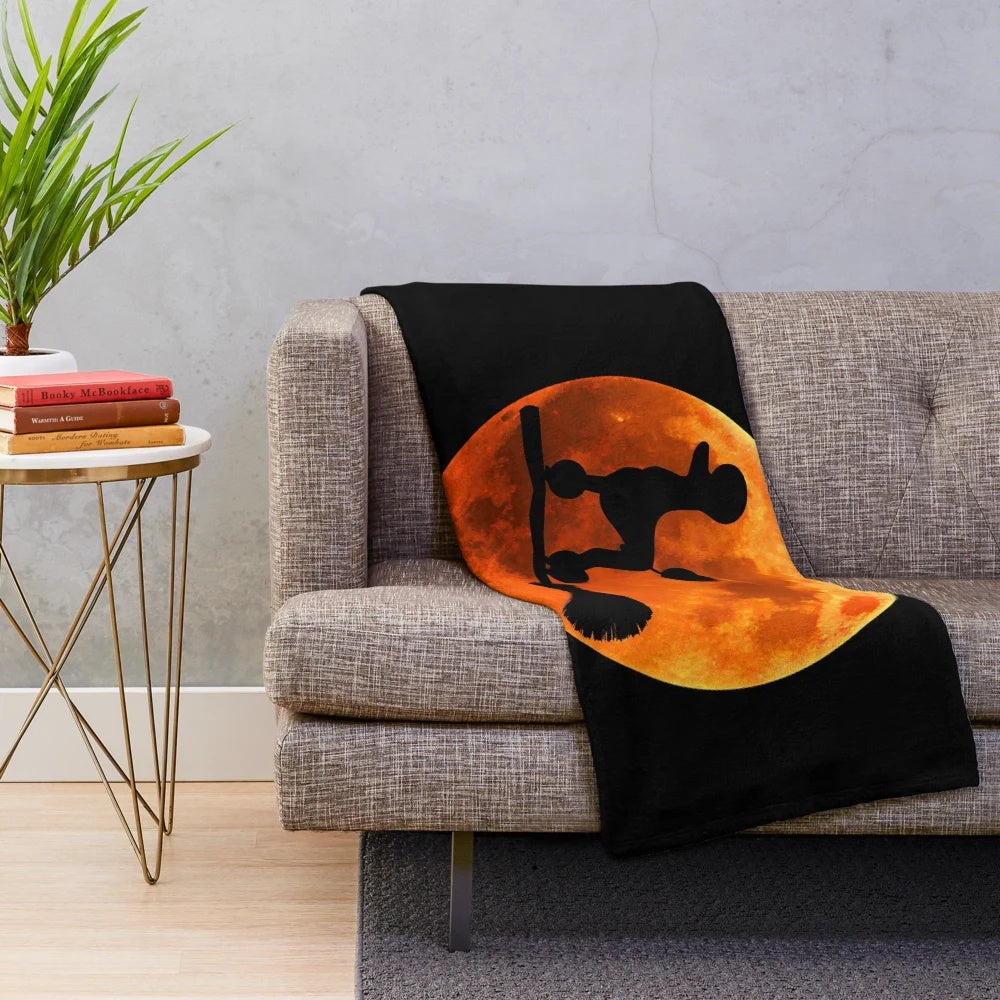 Poodle dog silhouette against the moon on a cozy plush blanket for Halloween
