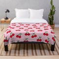 Colorful pop art inspired cherries pattern on a plush, cozy blanket