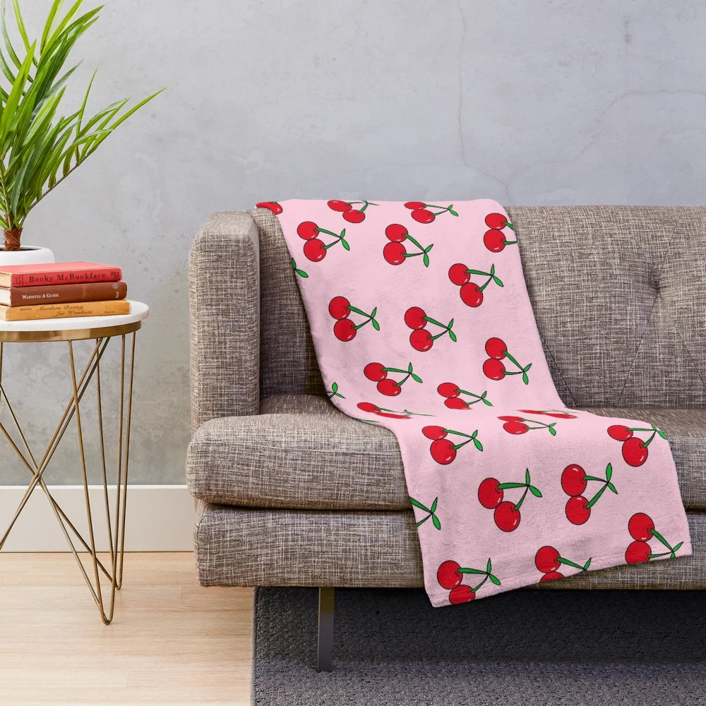 Colorful pop art inspired cherries pattern on a plush, cozy blanket