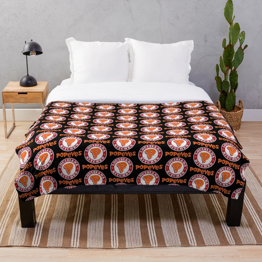 Popeyes-inspired plush blanket featuring the classic Popeyes logos and branding
