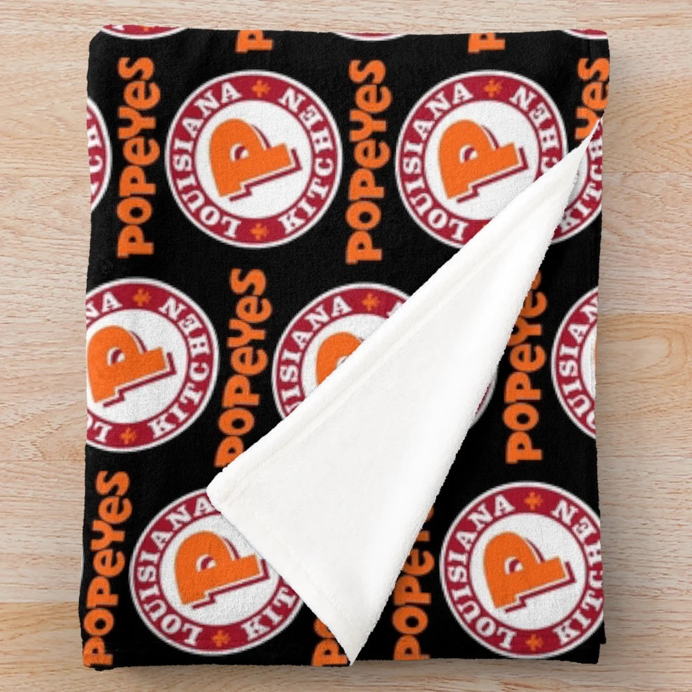 Popeyes-inspired plush blanket featuring the classic Popeyes logos and branding