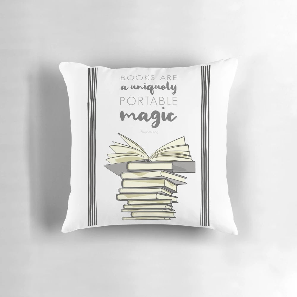 A portable decorative pillow featuring a digital illustration of a stack of books and a book quote.