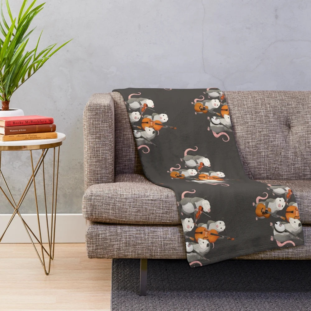 Possum band plush blanket with cartoon possums playing various musical instruments