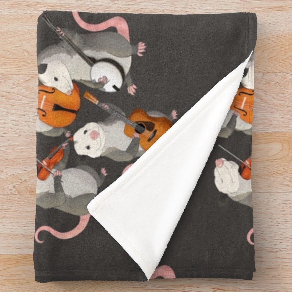 Possum band plush blanket with cartoon possums playing various musical instruments