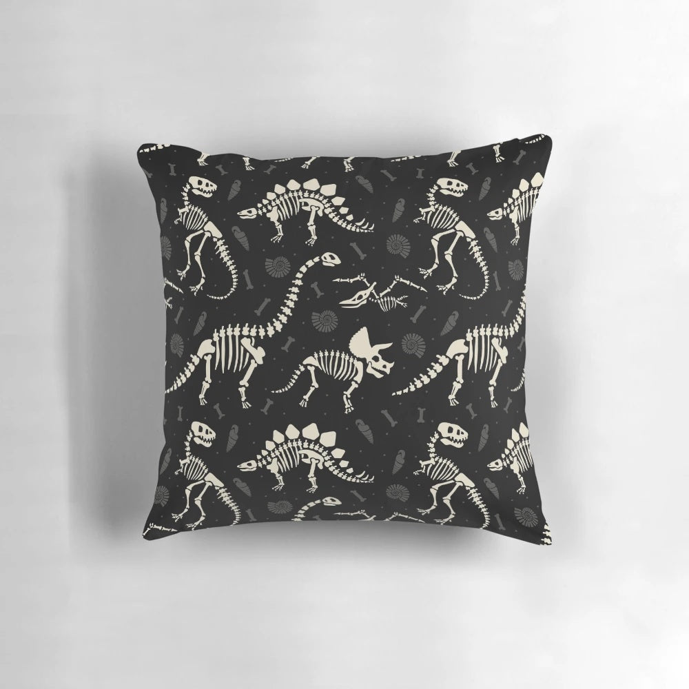 Black and white pillow with a dinosaur fossil design