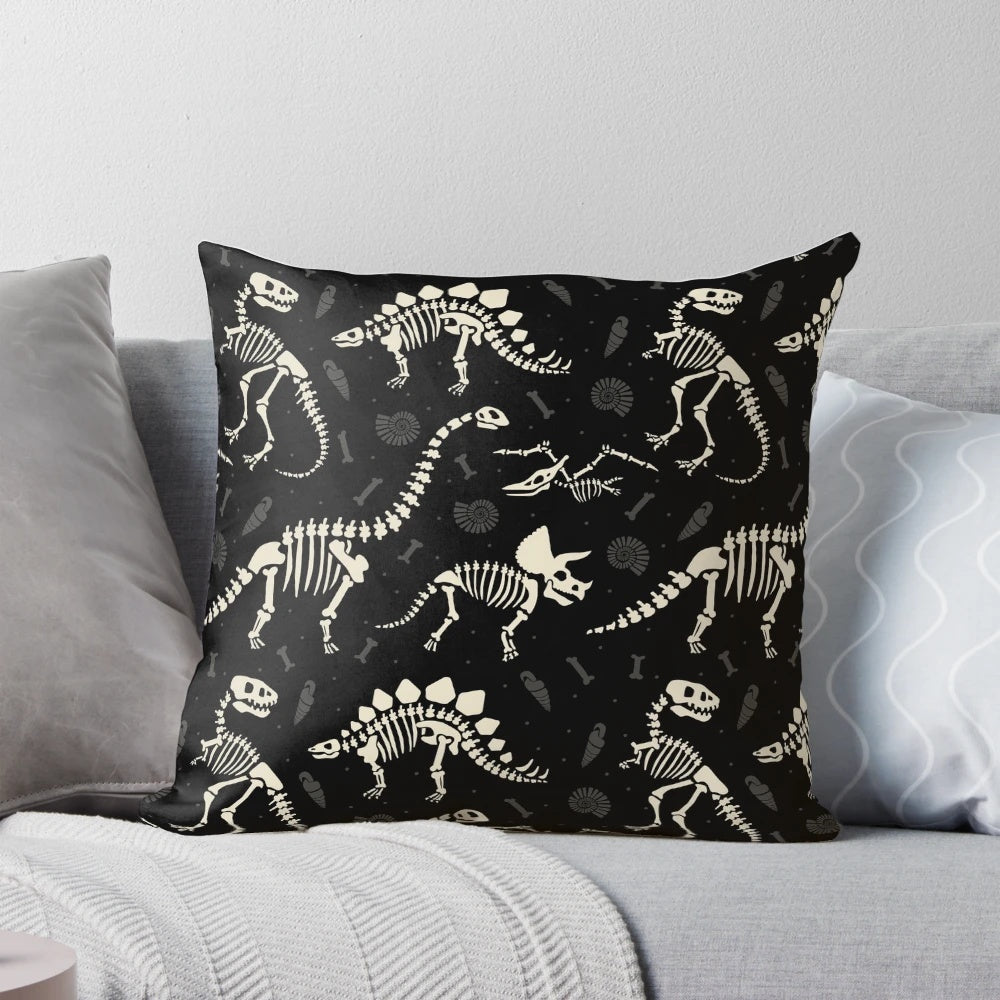 Black and white pillow with a dinosaur fossil design